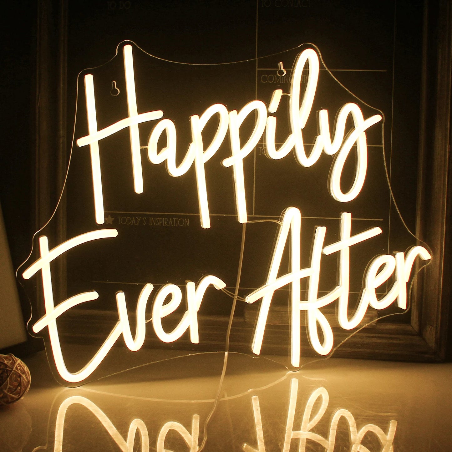 Das Bild zeigt ein wunderschön gestaltetes LED-Neonschild mit der Aufschrift „Happily Ever After“ in fließender Schreibschrift.