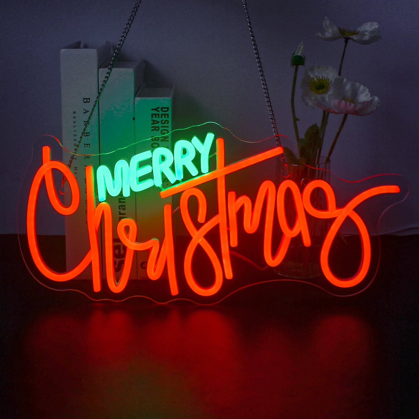 Ein leuchtendes LED-Neonschild mit dem festlichen Satz „Frohe Weihnachten“ in eleganter, fließender Schrift.