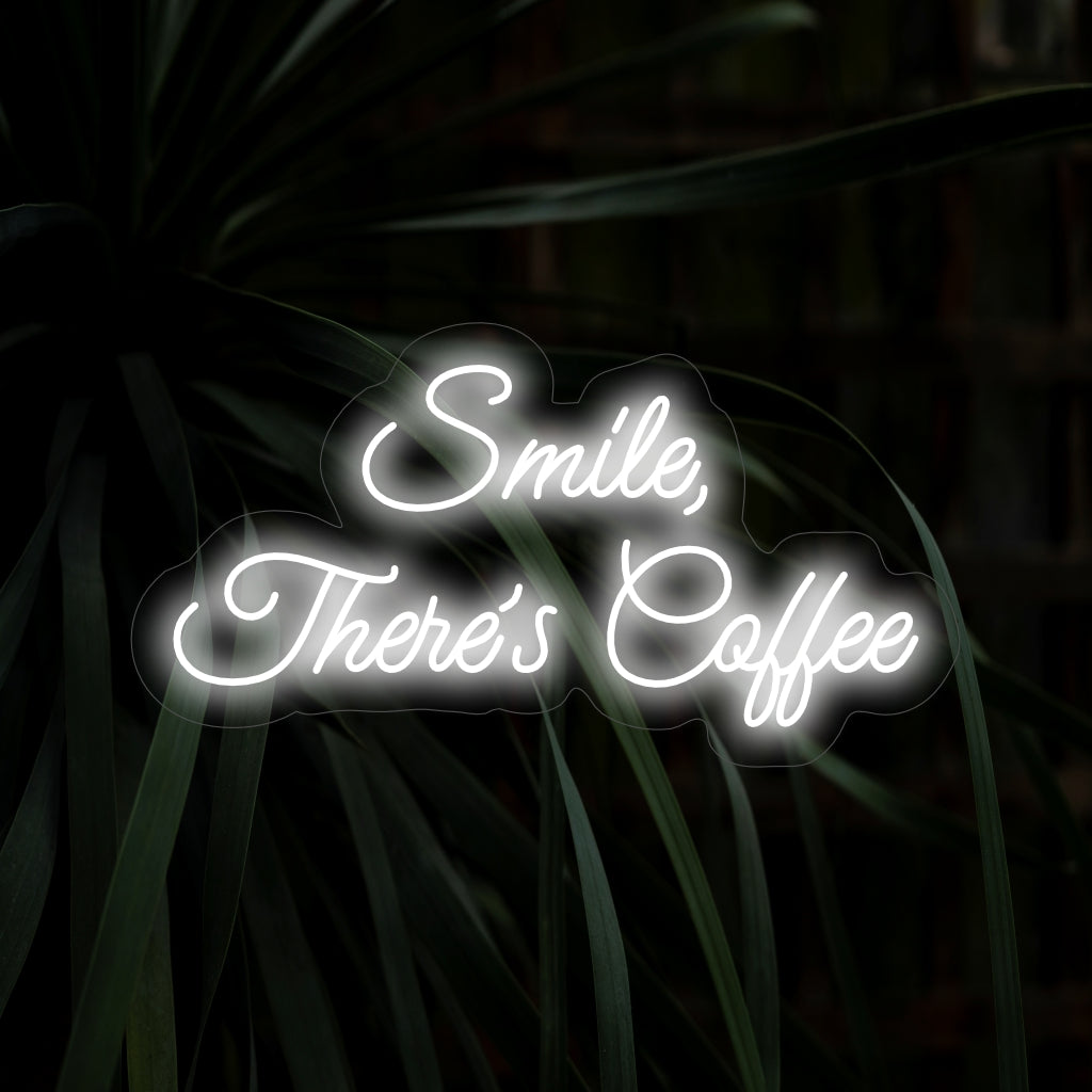 Das Neonschild „Smile, There’s Coffee“ verbreitet mit seiner aufmunternden Botschaft und dem Kaffeetassen-Design gute Laune und verbreitet einen herrlichen Schein, der für eine positive und warme Atmosphäre in Ihrem Raum sorgt.