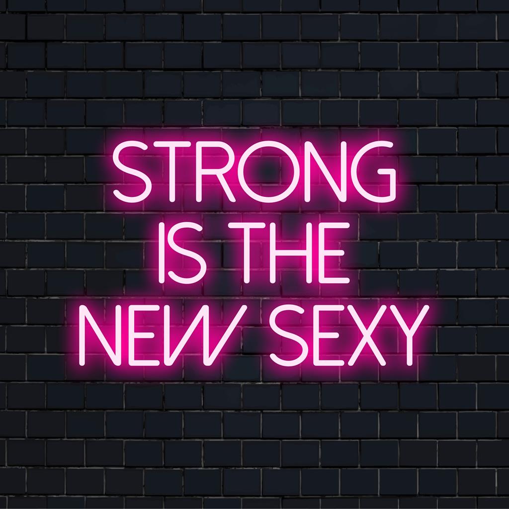LED-Neonschild mit dem Satz „Strong Is The New Sexy“; lebendige, motivierende Wandkunst, die in leuchtenden Farben leuchtet.