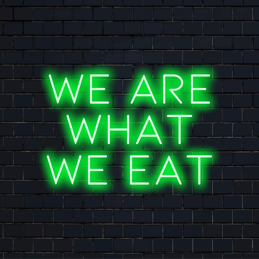 LED-Neonschild mit der Aufschrift „We Are What We Eat“ zeigt helle, ästhetische Neonlichtkunst, die perfekt zu einer modernen Einrichtung passt.