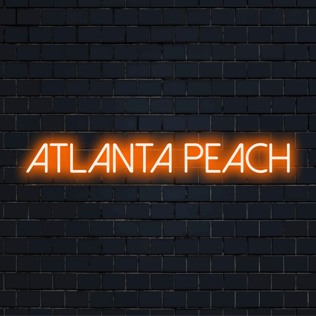 Atlanta Peach Neon Sign, bright LED glow on black brick background