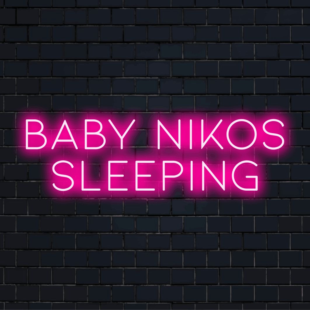 Baby Nikos Sleeping Personalized Neon Light with glowing wall decor on dark brick background