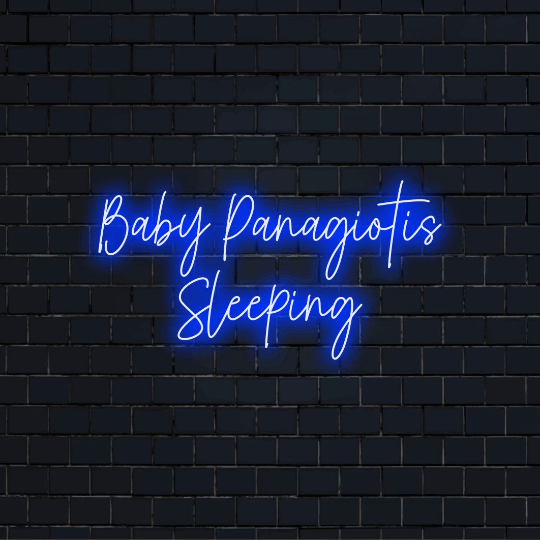 Baby Panagiotis Sleeping Personalized LED Neon Sign, bright neon lettering on black brick background