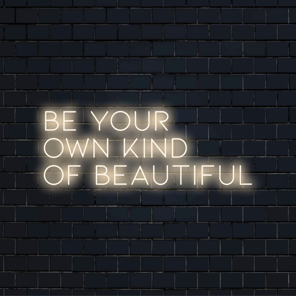 Be Your Own Kind Of Beautiful LED Neon Sign, glowing wall decor against brick backdrop