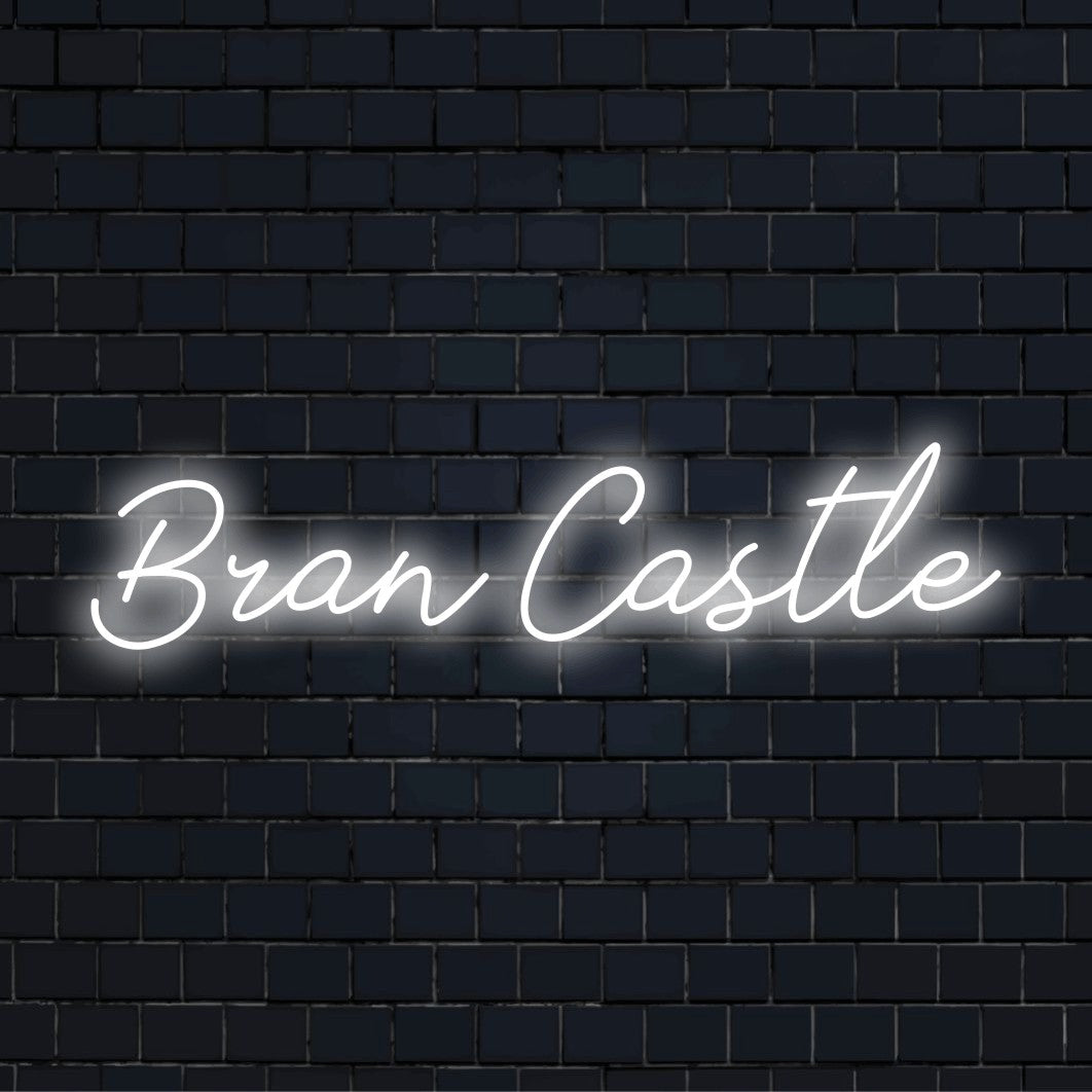 Bran Castle Neon Sign, bright LED glow against brick backdrop