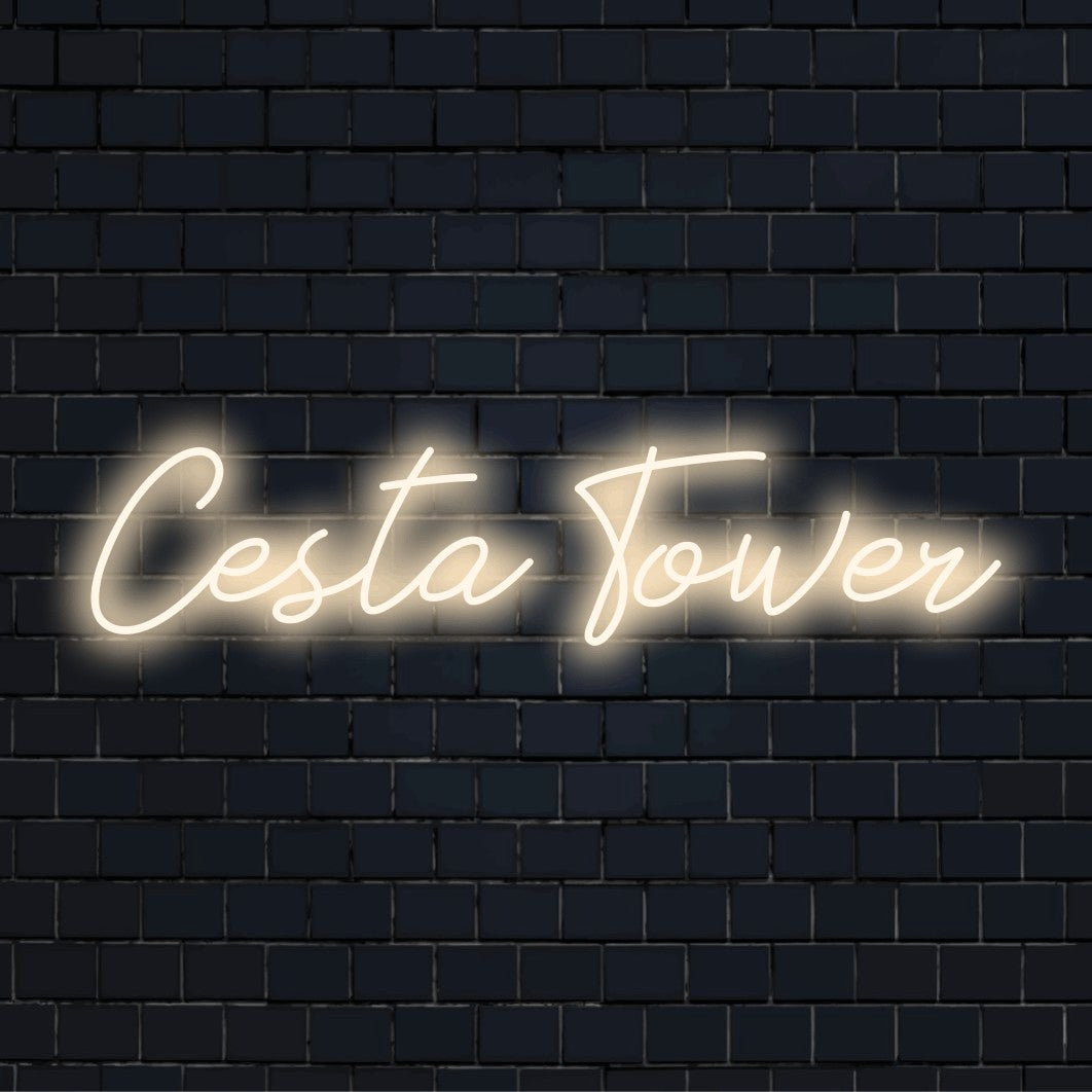 Cesta Tower LED Neon Sign, glowing neon text against brick backdrop