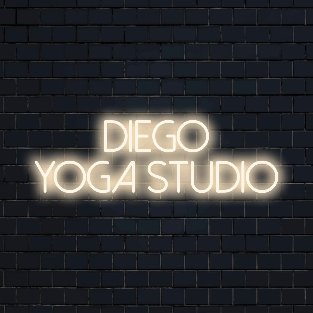 Diego Yoga Studio Custom Name Neon Sign, glowing wall decor against brick backdrop