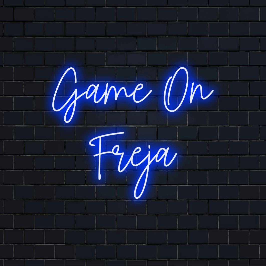 Game On Freja Personalized Neon Light with glowing wall decor against black brick wall