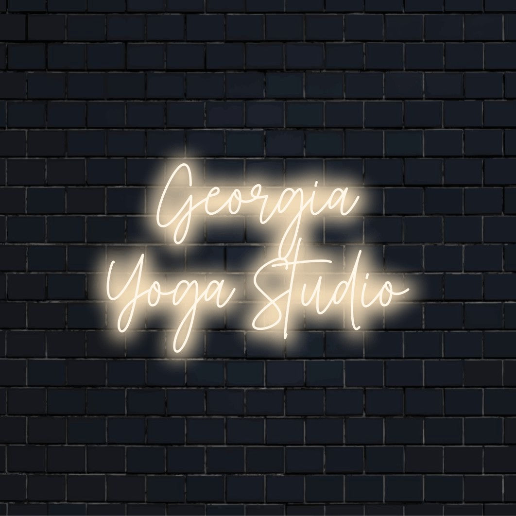 Georgia Yoga Studio Personalized LED Neon Sign, glowing lettering on black brick background