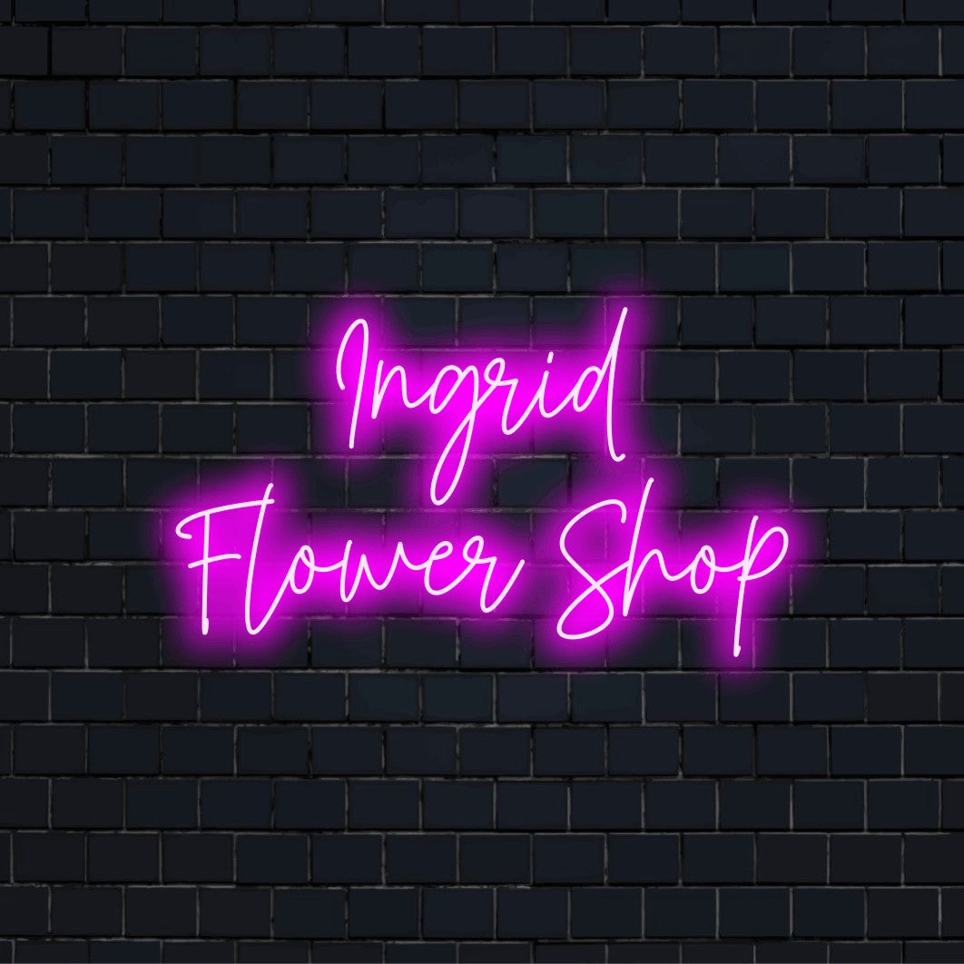 Ingrid Flower Shop Personalized Neon Light with glowing lettering against brick backdrop