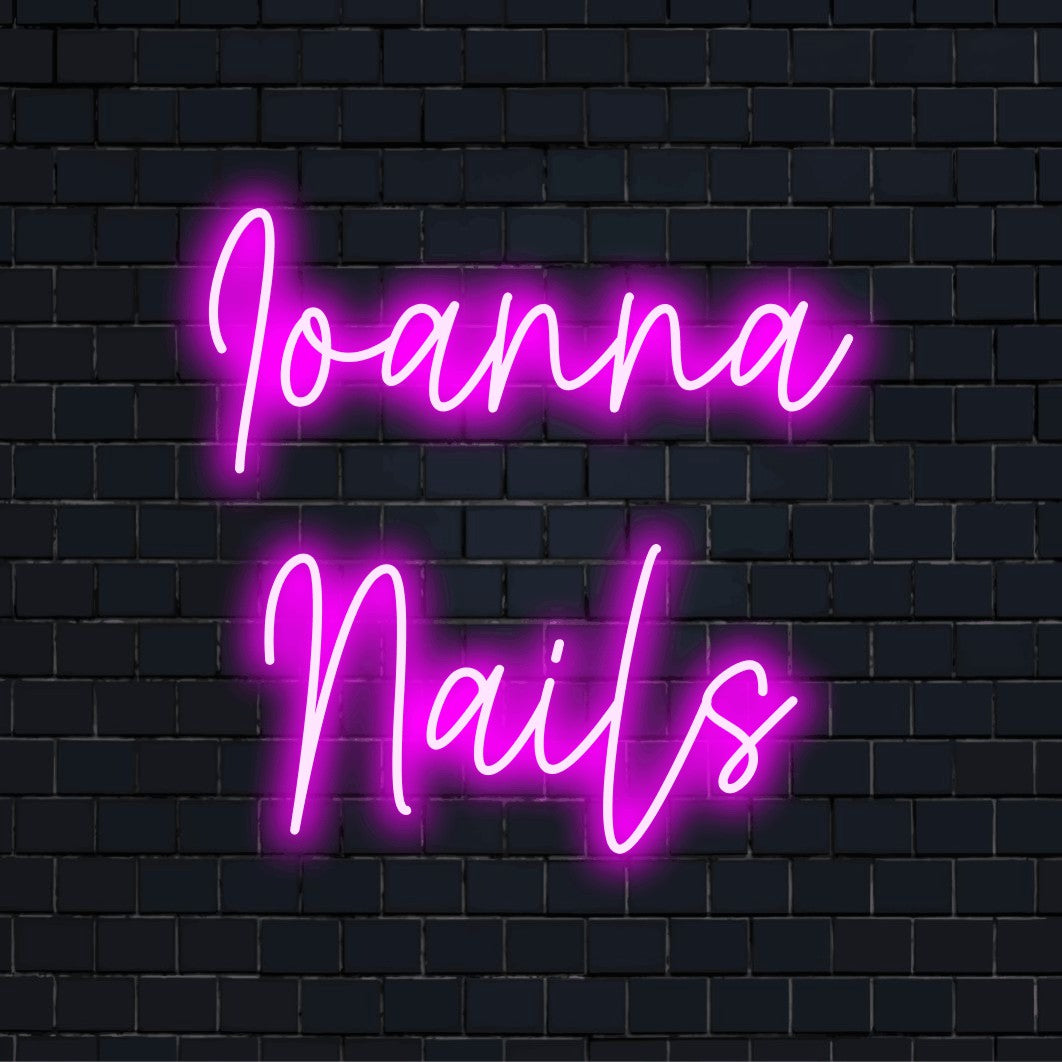 Ioanna Nails Custom Name Neon Sign, bright neon glow against black brick wall
