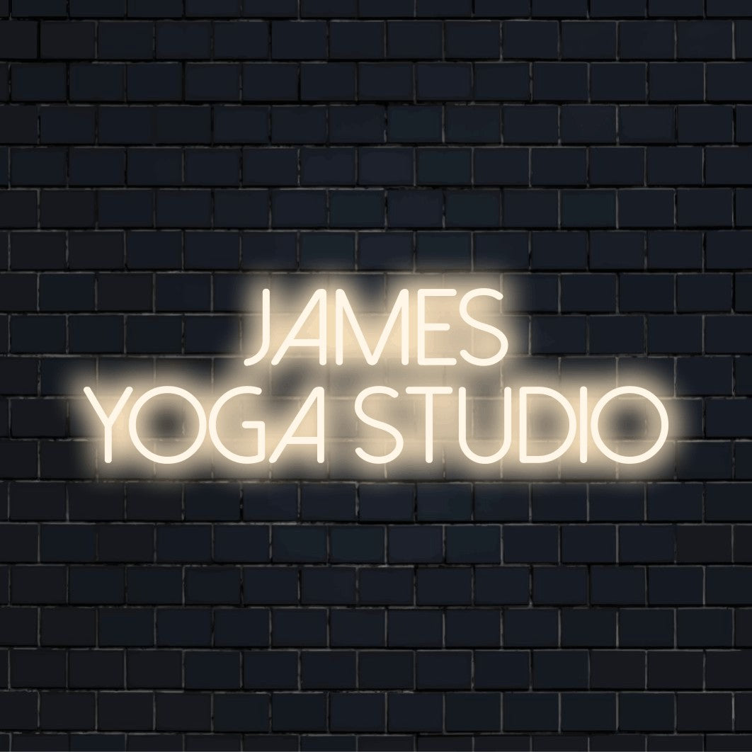 James Yoga Studio Personalized Neon Light with glowing wall decor on dark brick wall