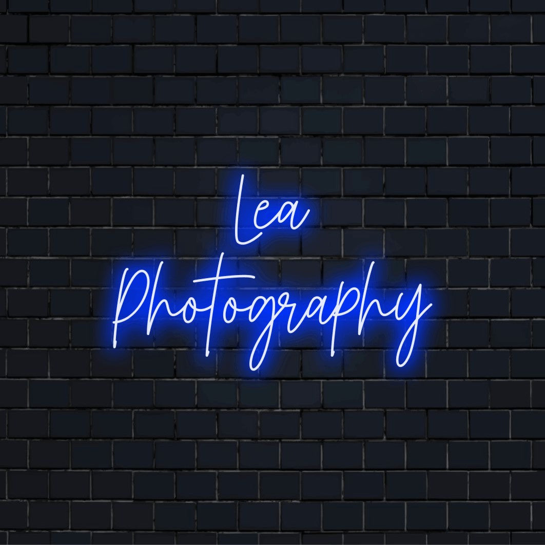 Lea Photography Personalized Neon Light with bright neon lettering against brick backdrop
