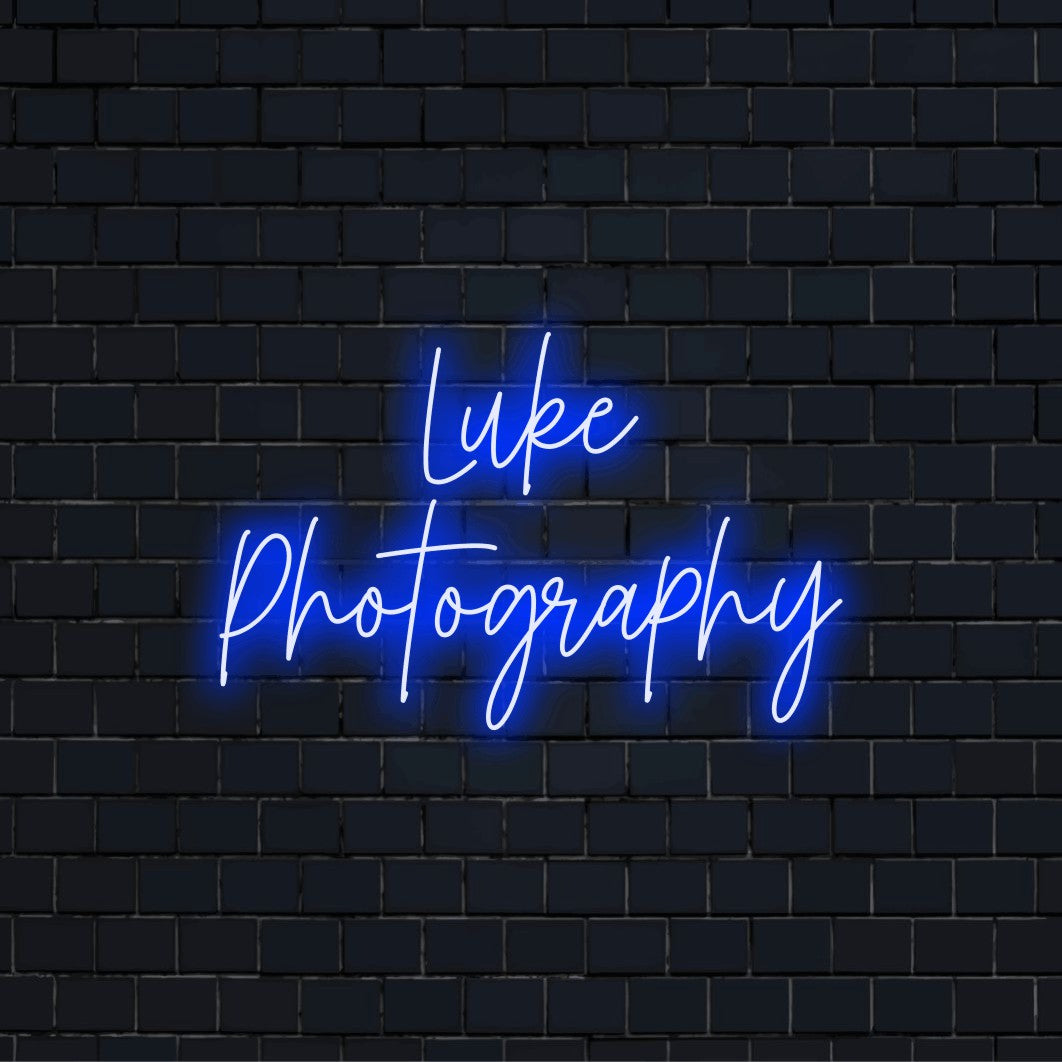 Luke Photography Personalized LED Neon Sign, glowing neon text on dark brick wall
