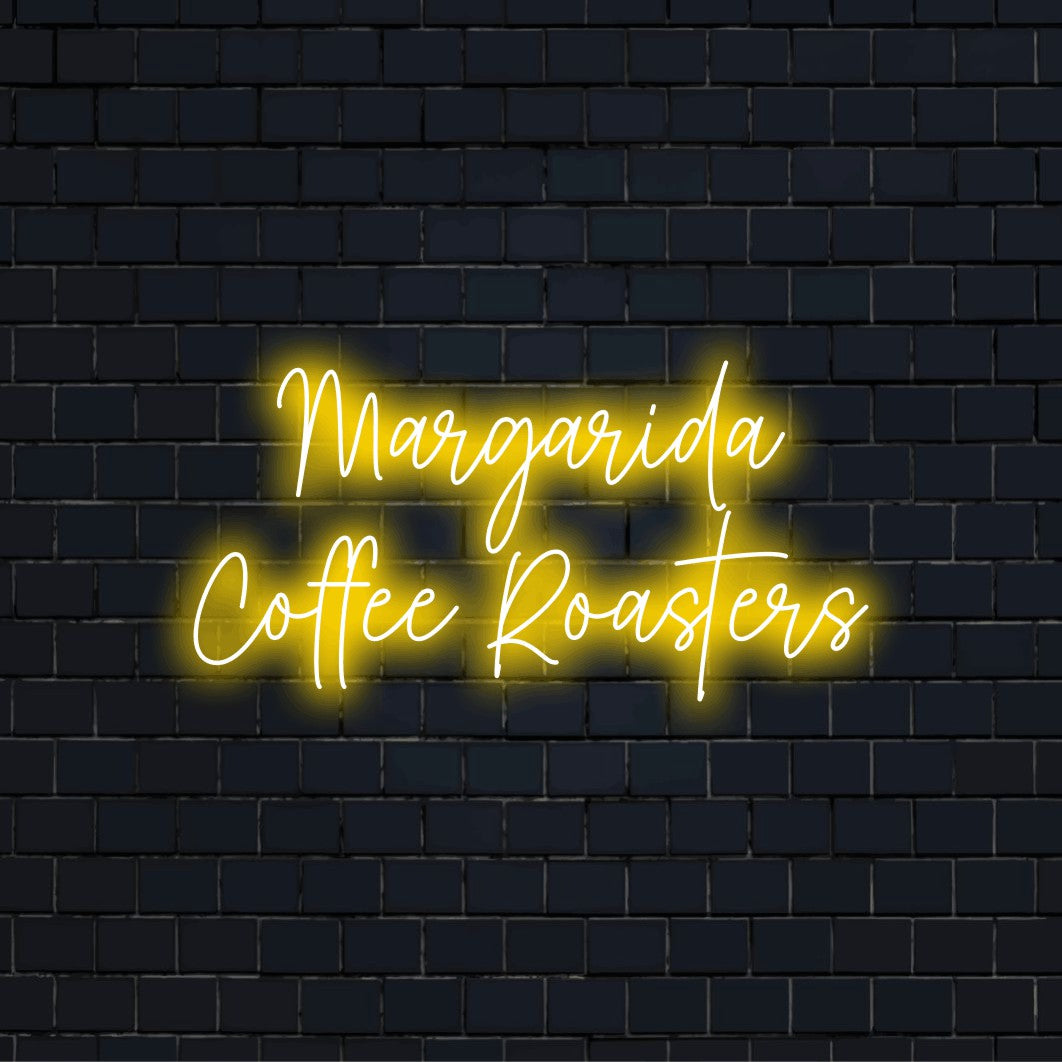 Margarida Coffee Roasters Personalized Neon Light with neon text light against brick backdrop