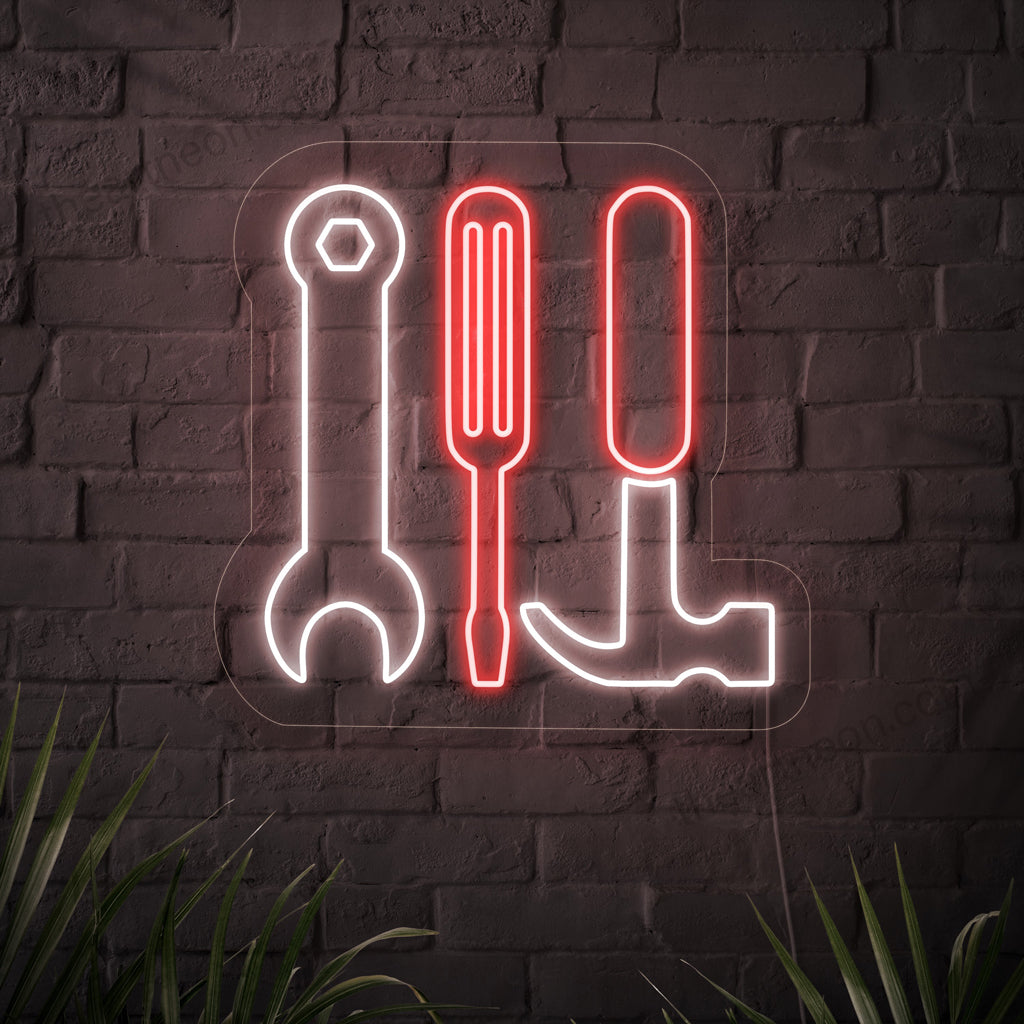 Ein auffälliges Neonschild mit den Symbolen eines Schraubenschlüssels, Hammers und Schraubenziehers.