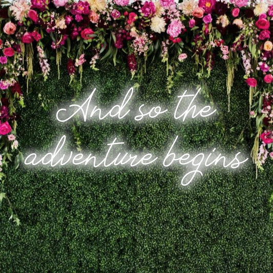 Custom LED neon sign with the phrase And So The Adventure Begins glowing vibrantly, perfect for personalized wall decor.