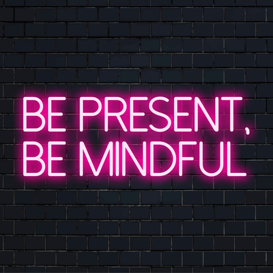 Custom made LED neon sign reads Be Present, Be Mindful in glowing, vibrant letters; personalized neon wall art.