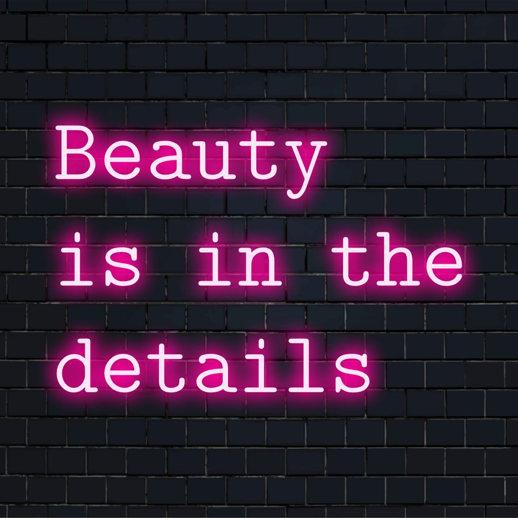 Custom LED neon sign reading Beauty Is In The Details, perfect for personalizing any space with vibrant, artistic flair.