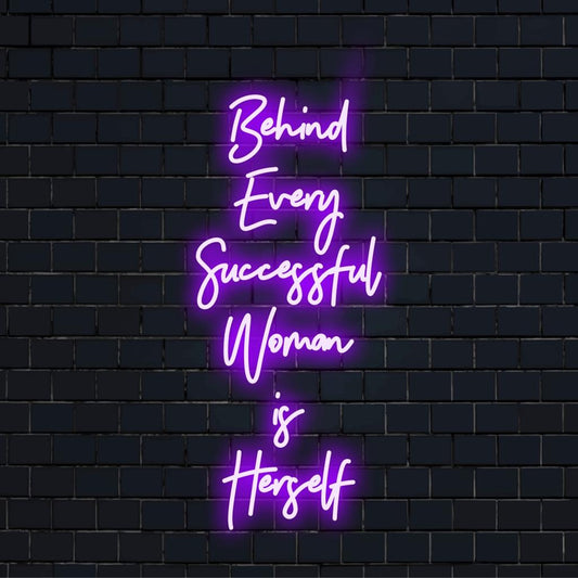 Custom handmade LED neon sign with the empowering quote Behind Every Successful Woman Is Herself in vibrant light decor.