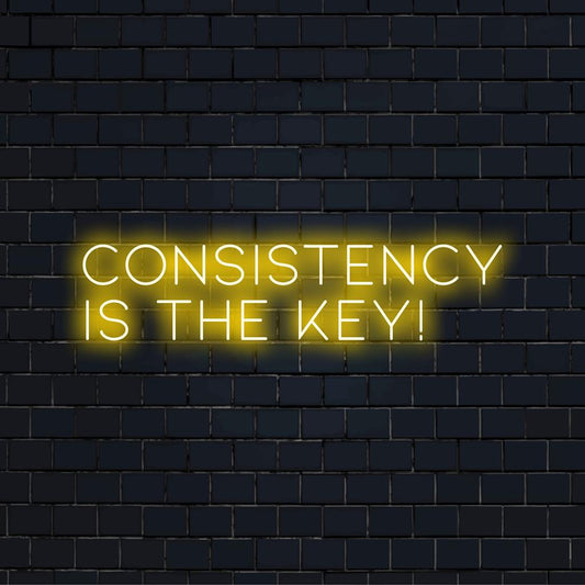 Custom made LED neon sign displaying 'Consistency Is The Key!', ideal for inspirational wall decor indoors. Non-specific design type.