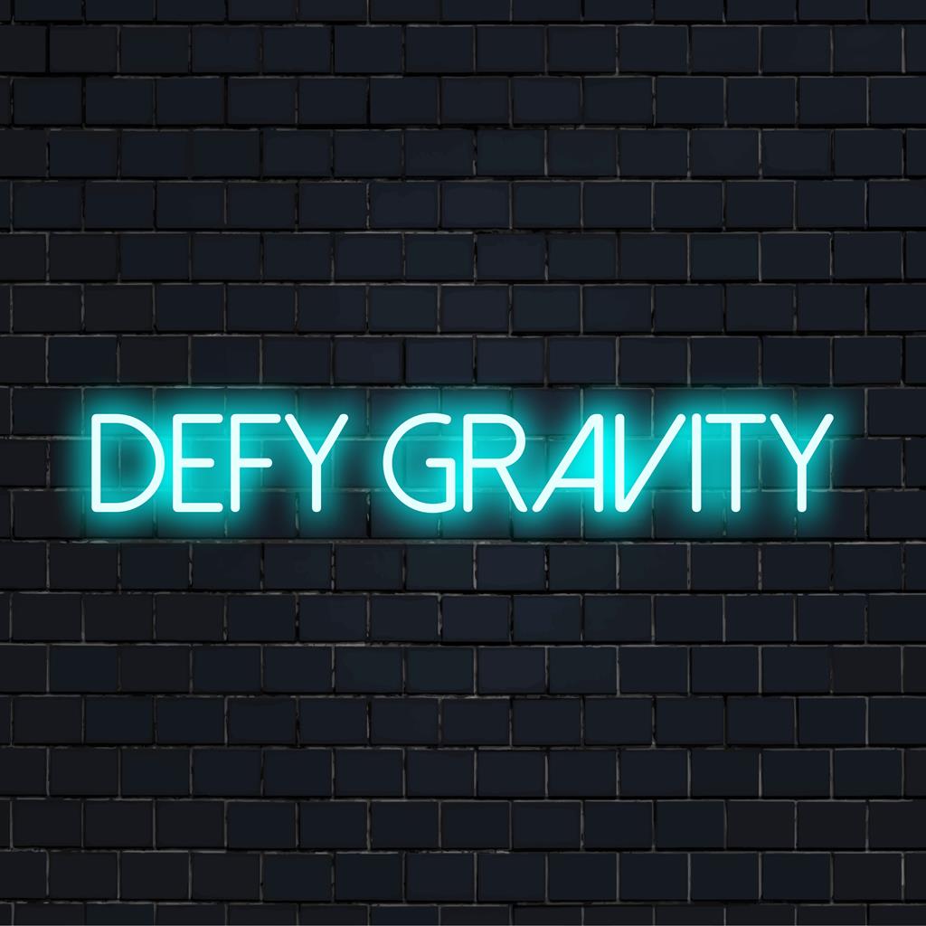 LED neon sign reading Defy Gravity, perfect for inspirational decor, with a mix of artistic lettering and luminous light.