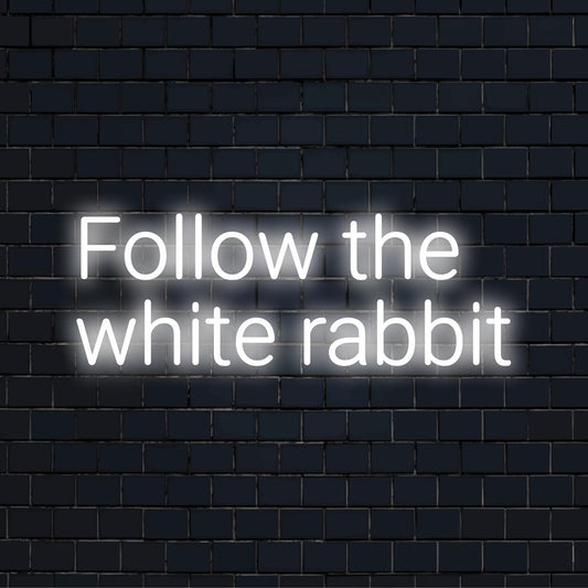 Custom LED neon sign reading Follow The White Rabbit, featuring glowing white letters. Ideal for unique neon wall art.