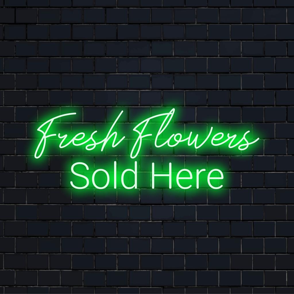 Bright and inviting, this custom made LED neon sign reads Fresh Flowers Sold Here for an eye-catching retail display.