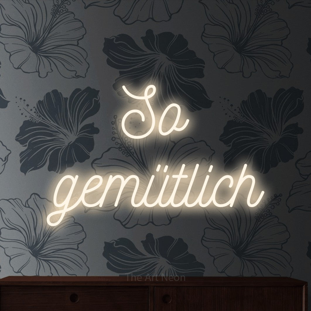 LED neon sign reading “So gemütlich”, arranged in 2 lines.