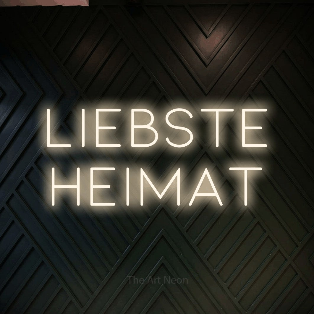 LED neon sign reading “liebste heimat”, arranged in 2 lines.
