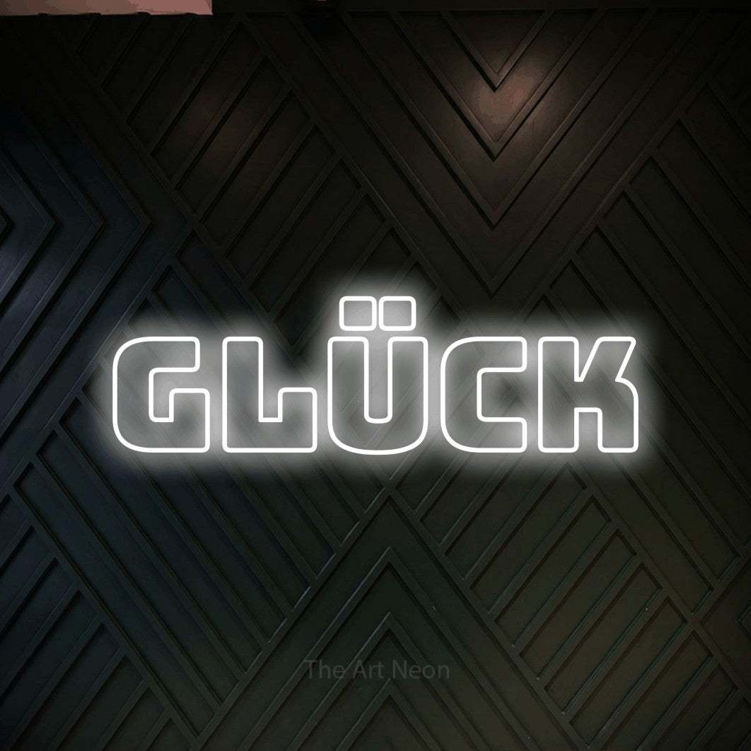 LED neon sign reading “GLÜCK”, arranged in a single line.