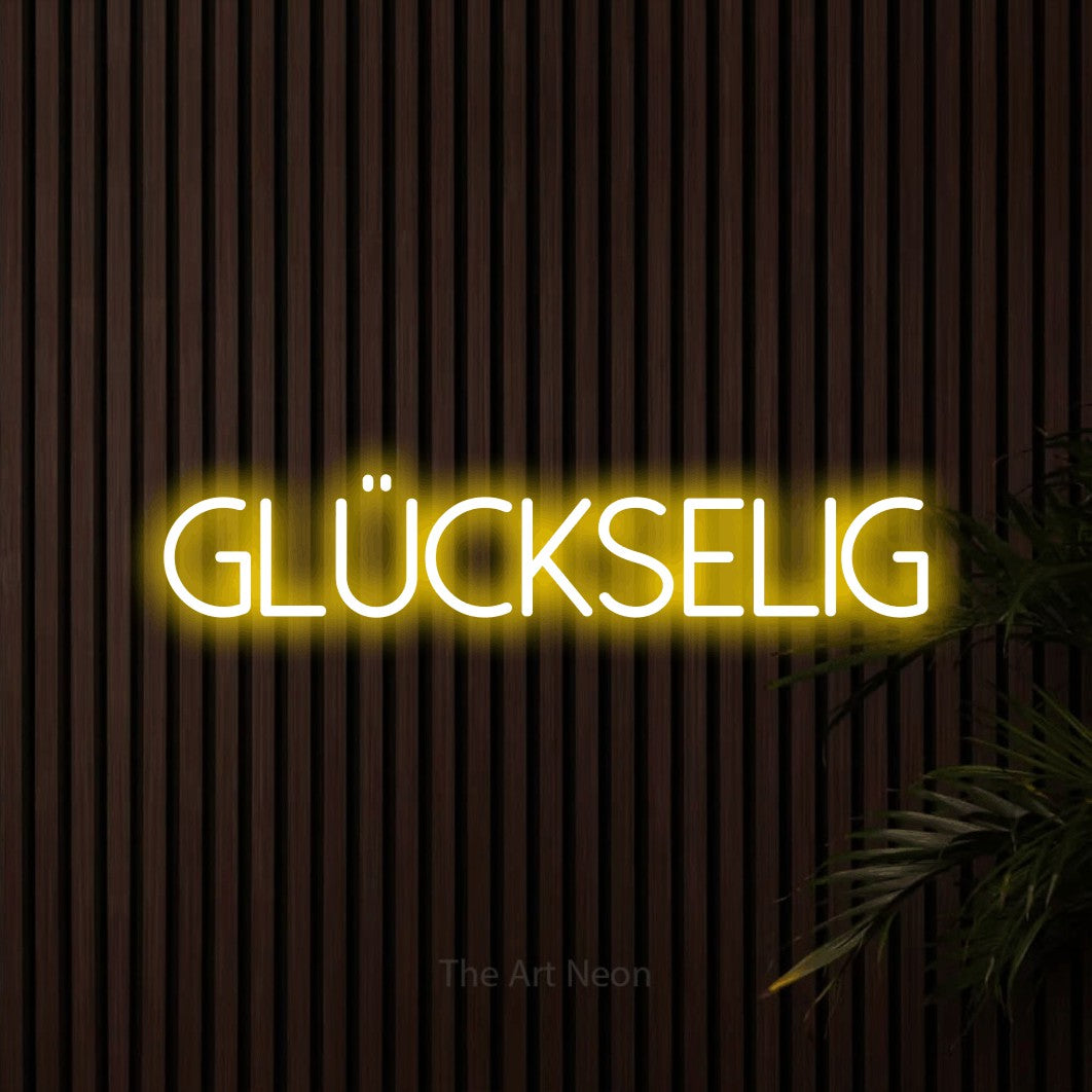 LED neon sign reading “glückselig”, arranged in a single line.