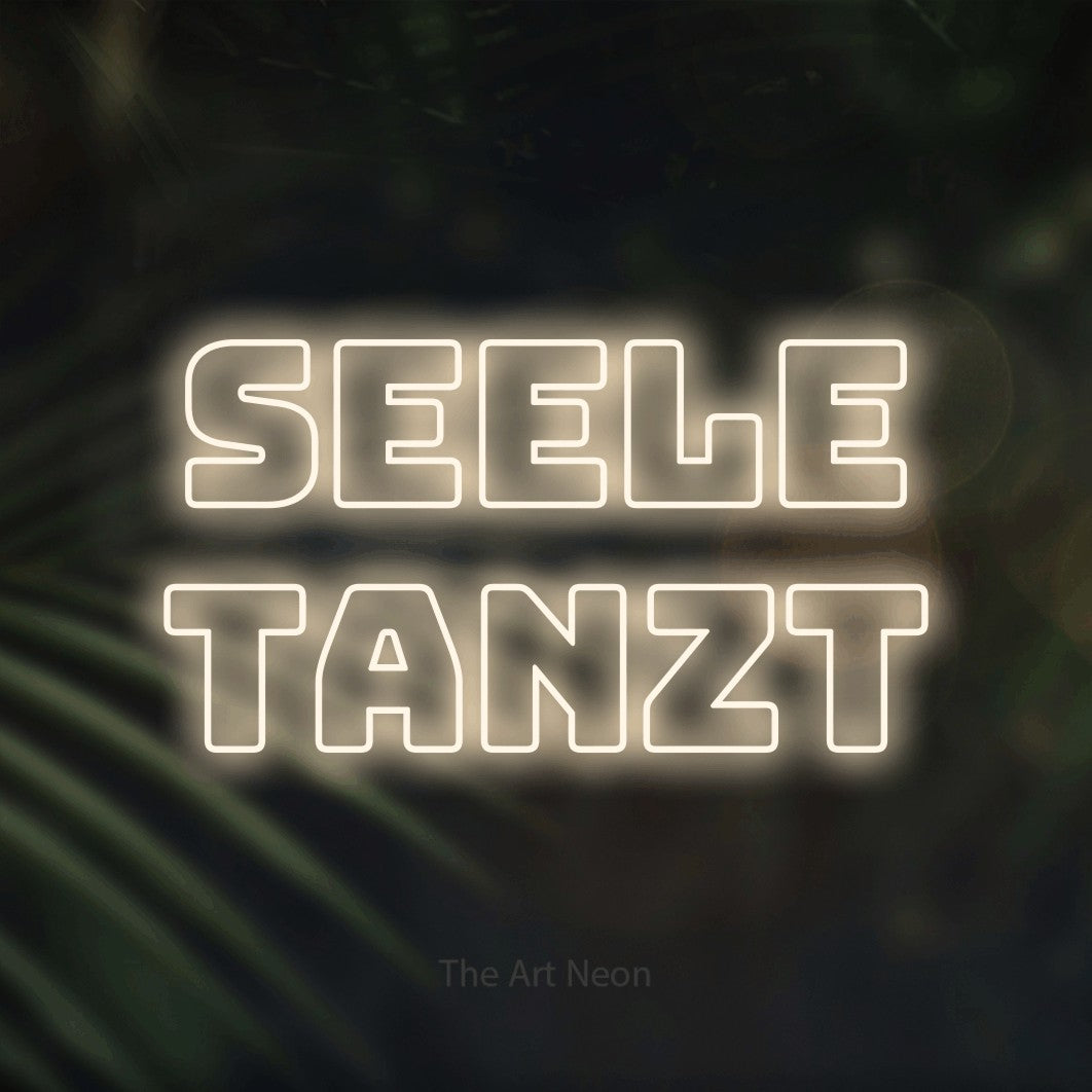 LED neon sign reading “SEELE TANZT”, arranged in 2 lines.