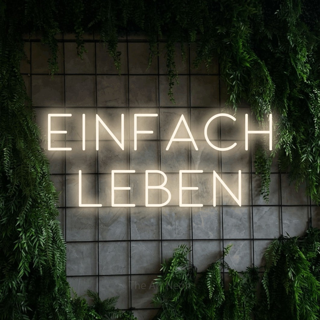 LED neon sign reading “EINFACH LEBEN”, arranged in 2 lines.