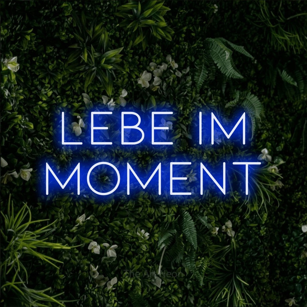 LED neon sign reading “lebe im MOMENT”, arranged in 2 lines.