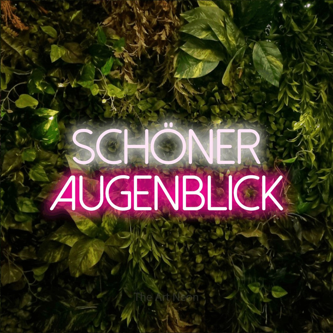 LED neon sign reading “schöner augenblick”, arranged in 2 lines.