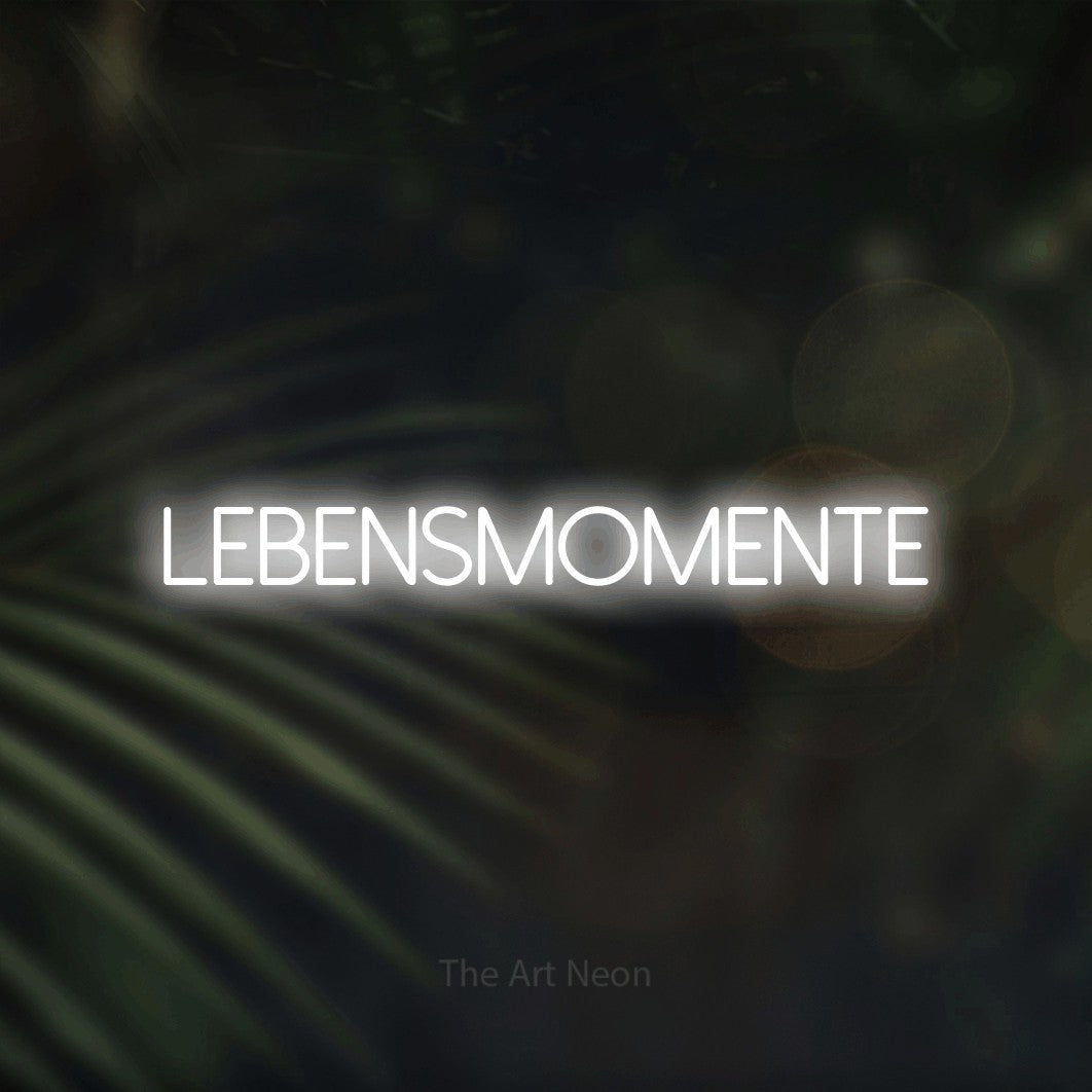 LED neon sign reading “LEBENSMOMENTE”, arranged in a single line.