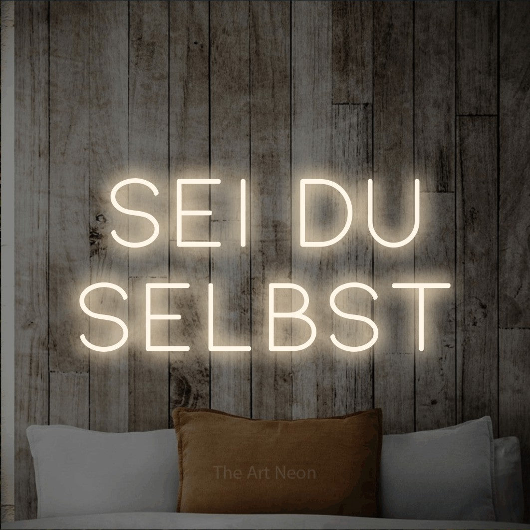 LED neon sign reading “Sei du selbst”, arranged in 2 lines.