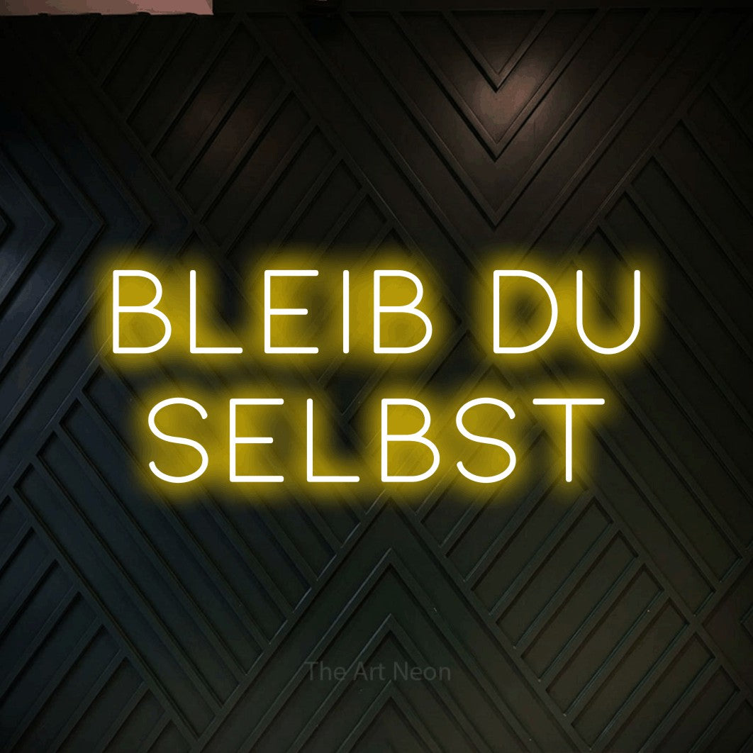 LED neon sign reading “BLEIB DU SELBST”, arranged in 2 lines.