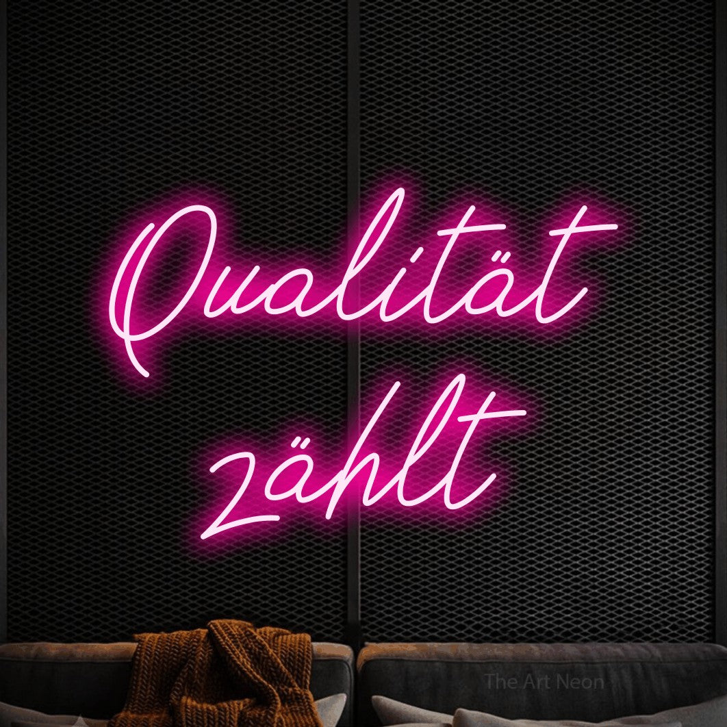 LED neon sign reading “Qualität zählt”, arranged in 2 lines.