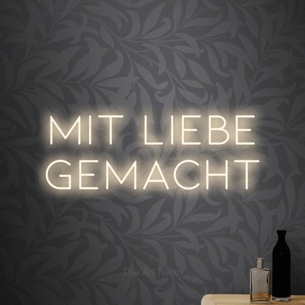 LED neon sign reading “MIT LIEBE GEMACHT”, arranged in 2 lines.