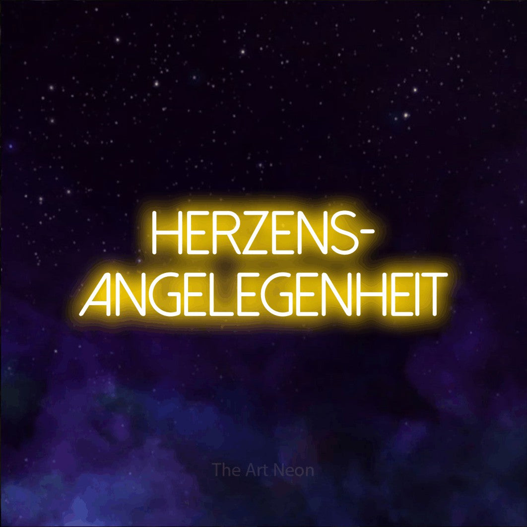 LED neon sign reading “herzens- angelegenheit”, arranged in 2 lines.