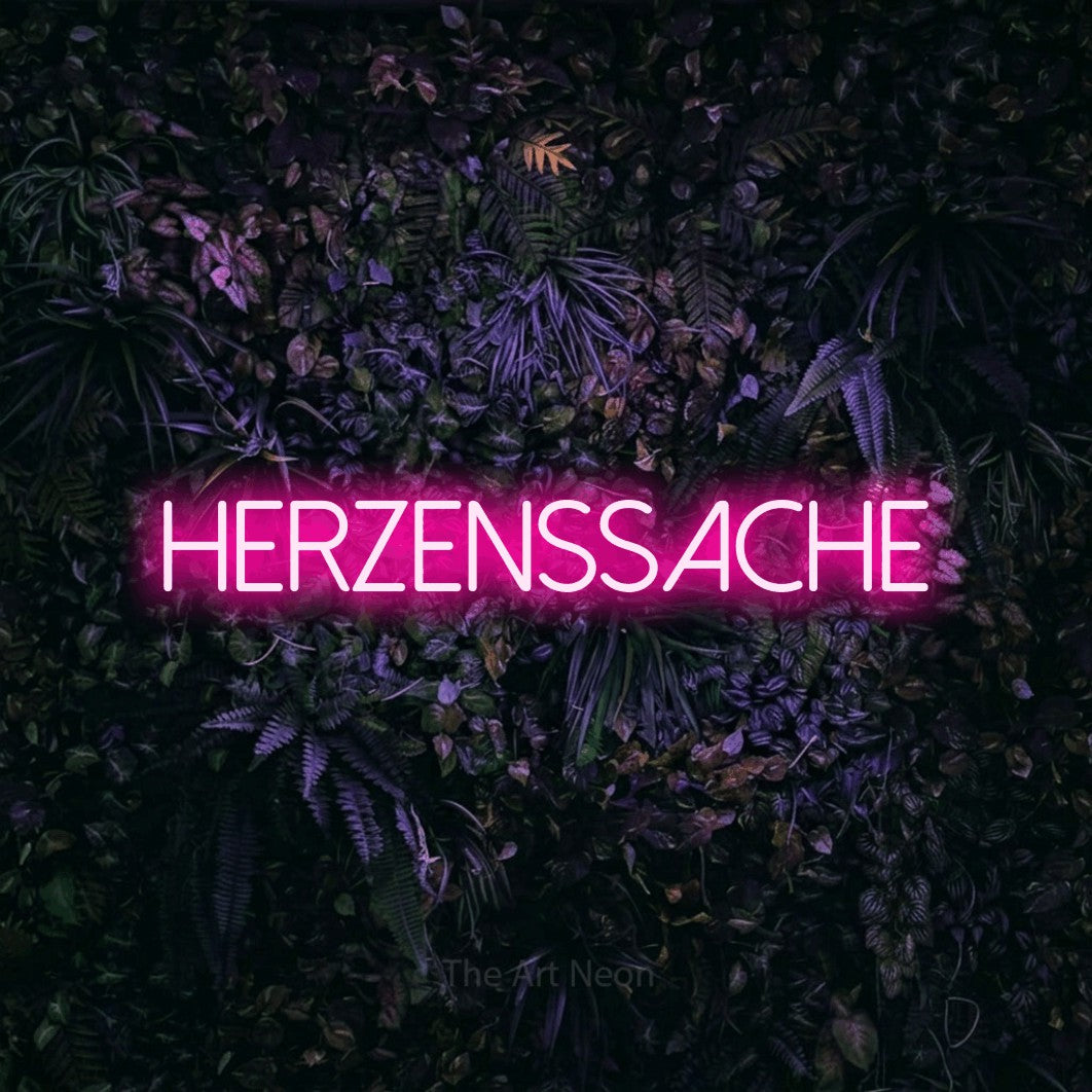 LED neon sign reading “Herzenssache”, arranged in a single line.