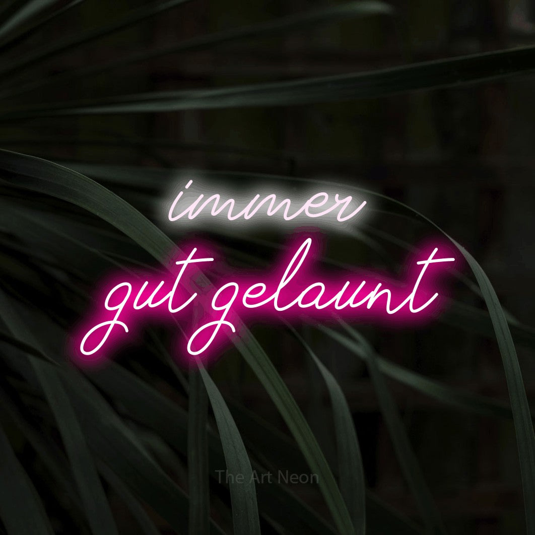 LED neon sign displaying “immer gut gelaunt”.