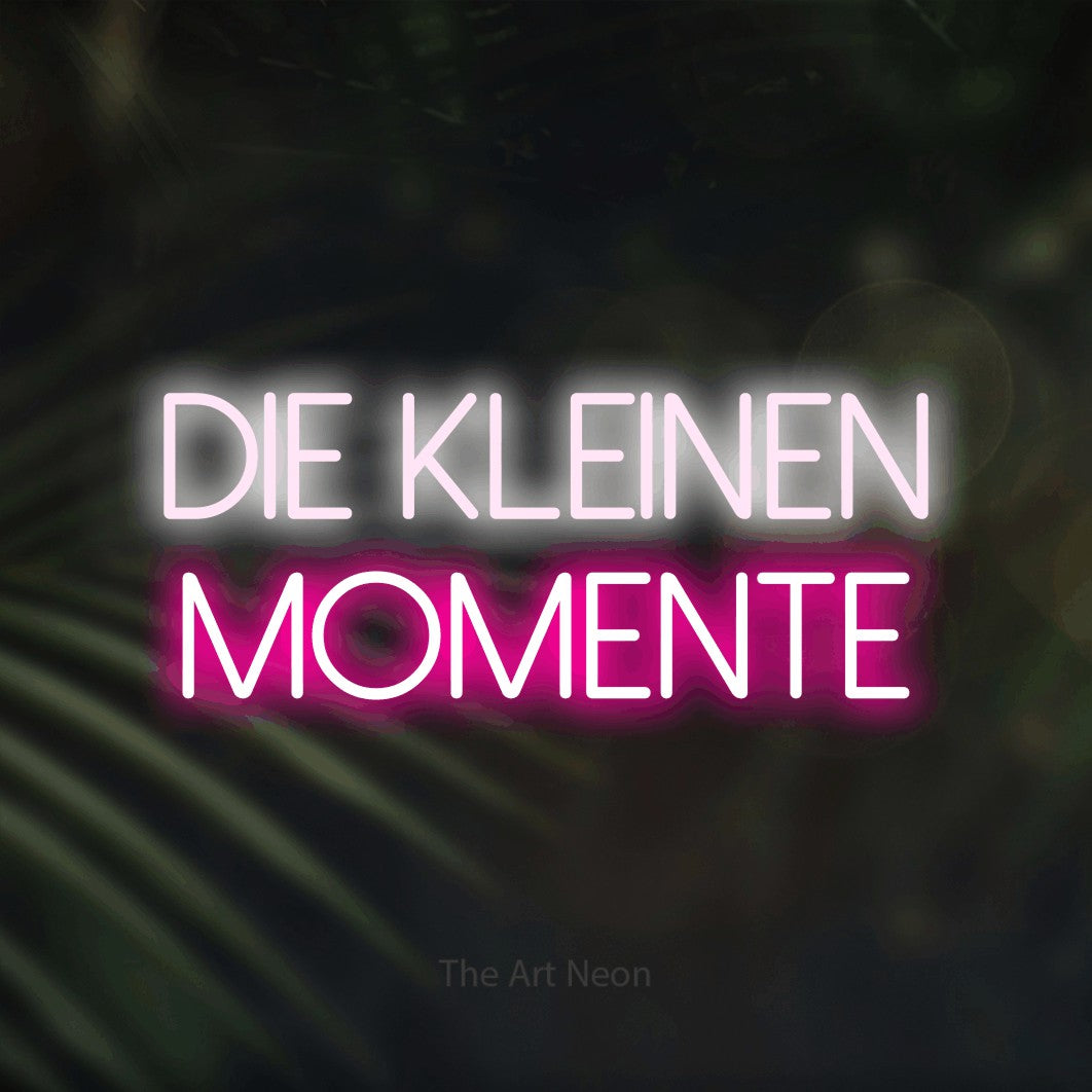 LED neon sign reading “Die kleinen Momente”, arranged in 2 lines.