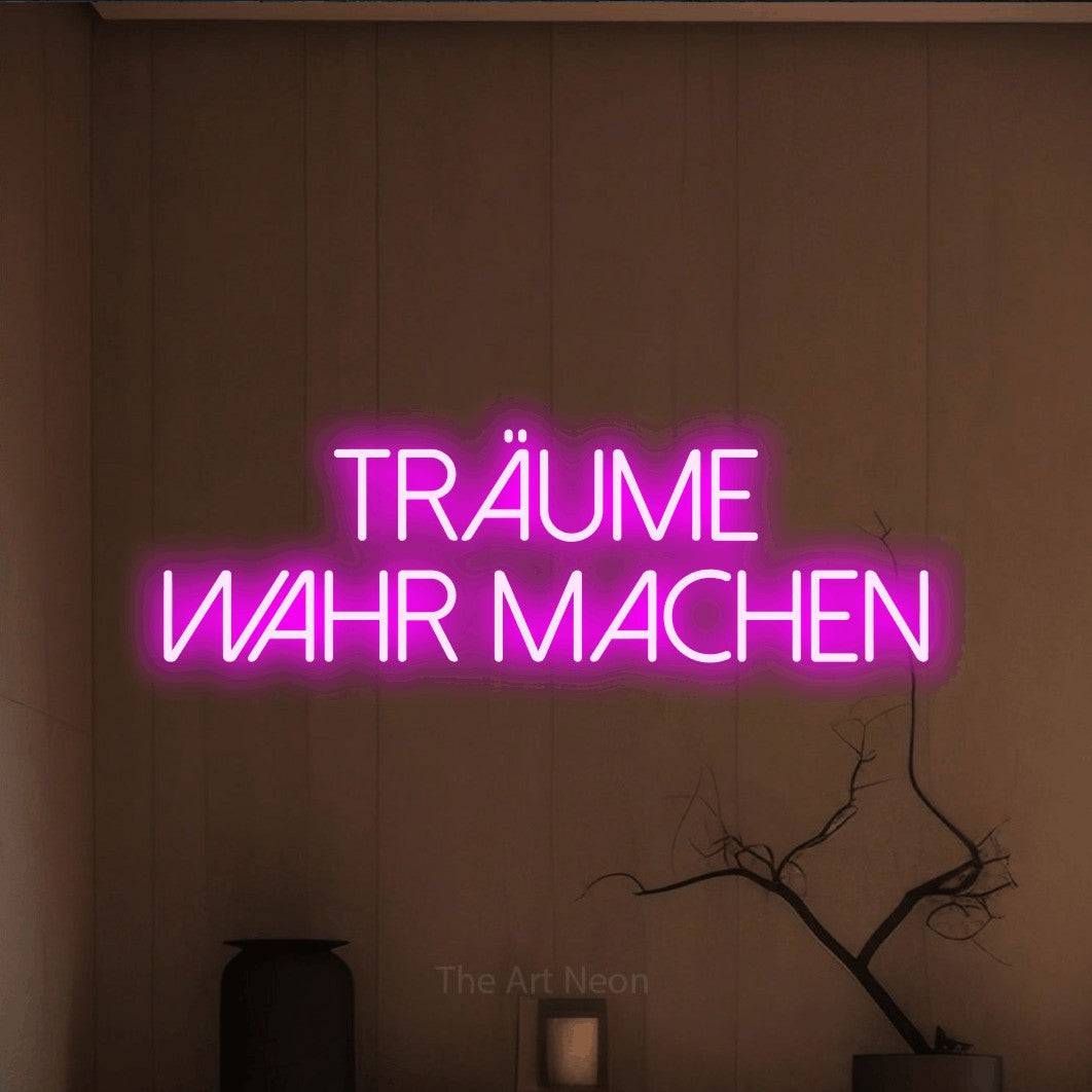 LED neon sign reading “träume wahr machen”, arranged in 2 lines.