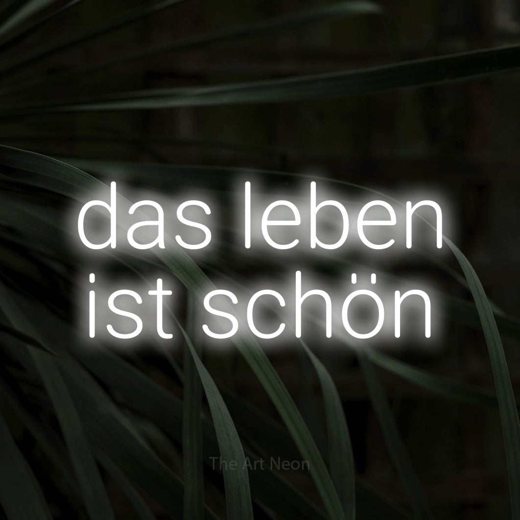 LED neon sign reading “das leben ist schön”, arranged in 2 lines.