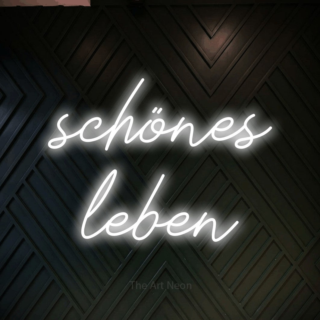 LED neon sign reading “schönes leben”, arranged in 2 lines.