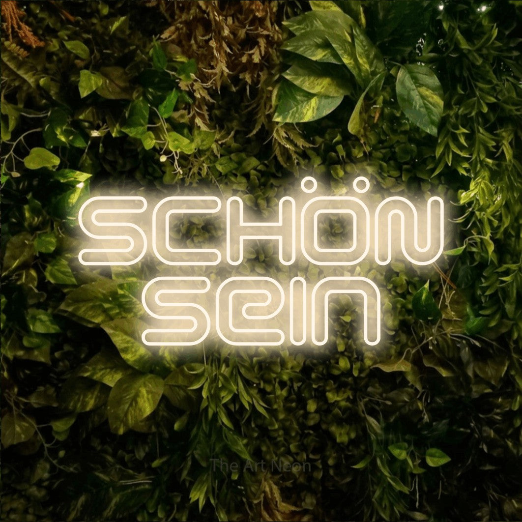 LED neon sign reading “SCHÖN sein”, arranged in 2 lines.